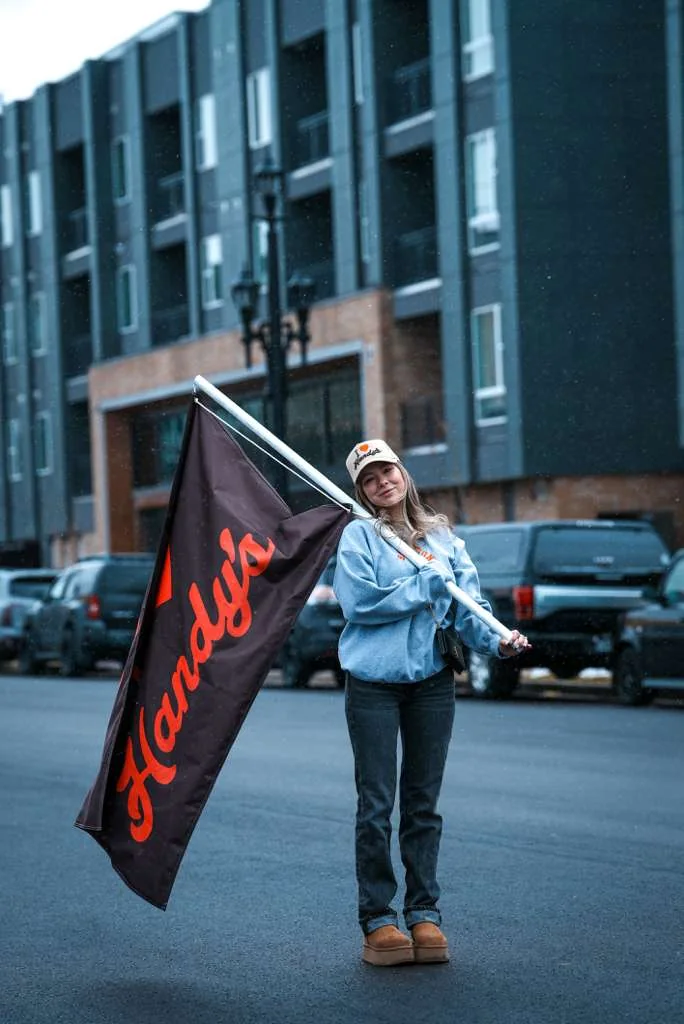 A Handy's supporter waving the Handy's flag at a parade