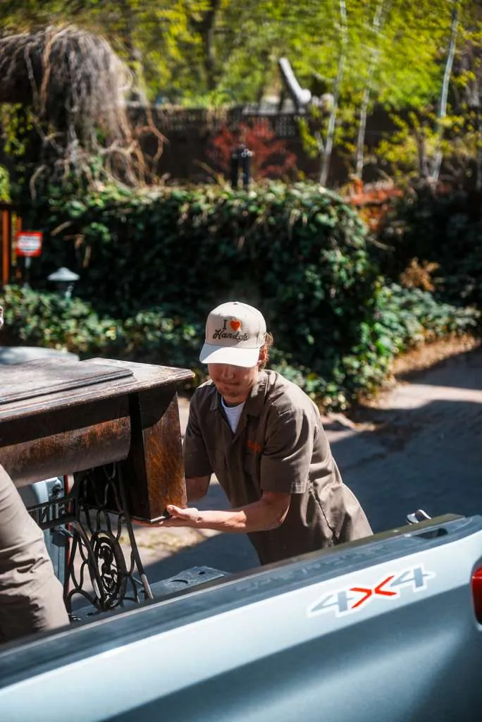 A Handy's technician loading a pickup truck