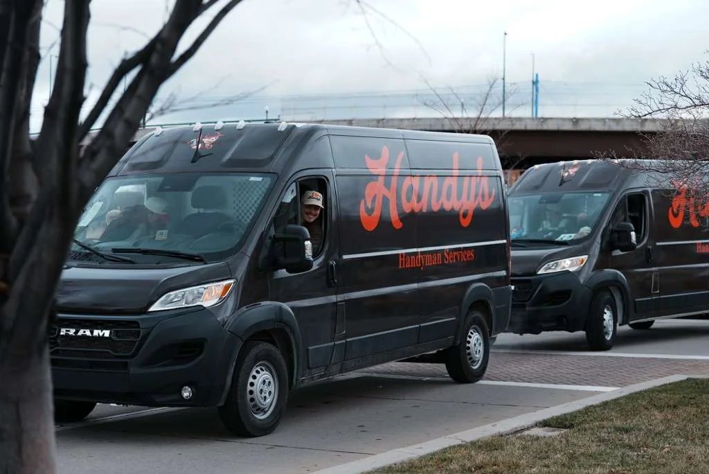 Two Handy's vans parked on a street