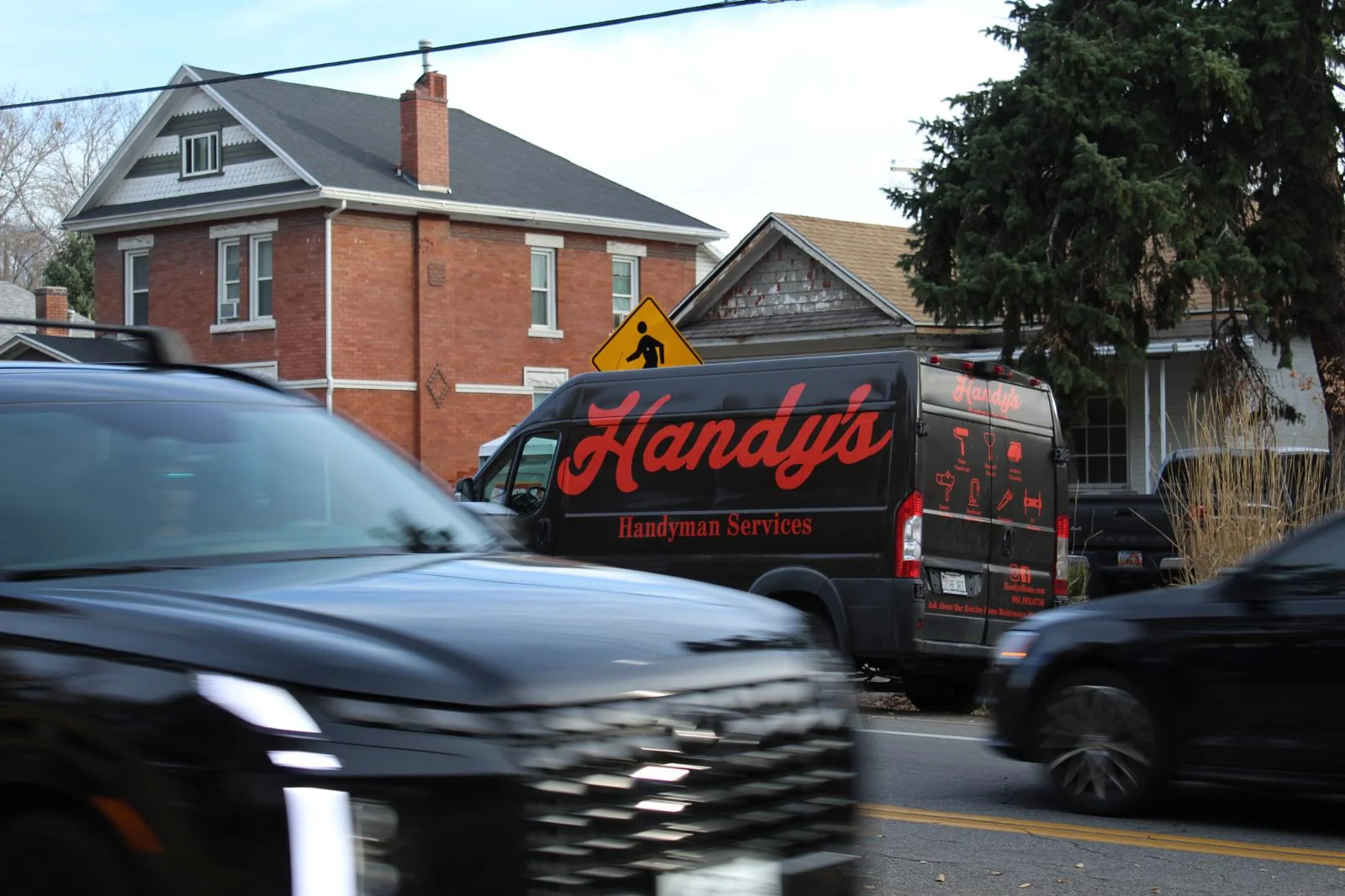 The Handy's van on a Salt Lake City street lined with brick homes